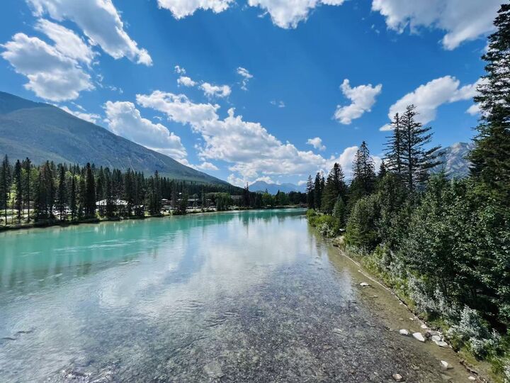 The Bow River runs right through Banff. The water comes from glaciers high above and stays bright turquoise even in the middle of town.